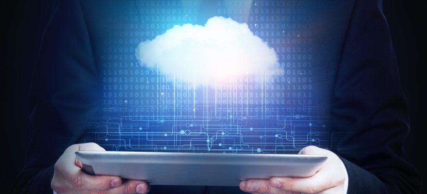 Businessman holding tablet with cloud floating