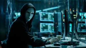 Computer hacker with a face mask and hoodie