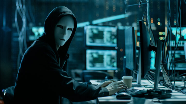 Computer hacker with a face mask and hoodie