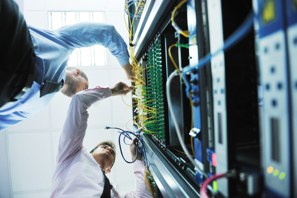 Men working on a network server rack